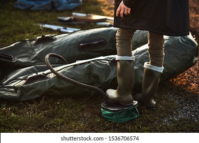 Teen Boy Ready Inflatable Boat To Go Fishing On Lake