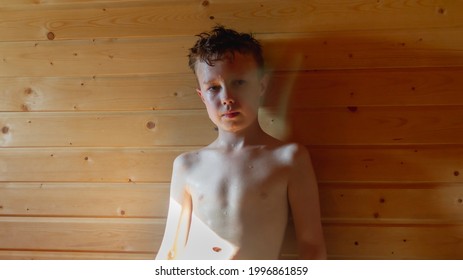 Teen Boy Steaming In A Russian Bath, Drops Of Sweat And Water Flowing Down The Child's Face.