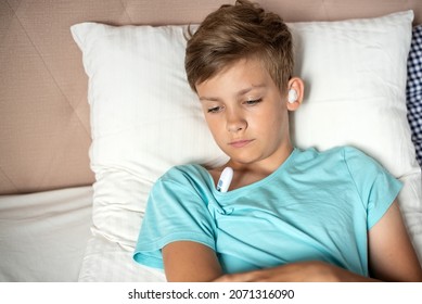 Teen Boy Suffering From Otitis With Sterile Cotton Wool In His Ears. Earache, Children Otitis Media, Acute Ear Pain, Inflammatory Disease Of The Middle Ear