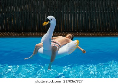 Teen Boy Sunbathing On Inflatable Swan Stock Photo 2170367927 ...