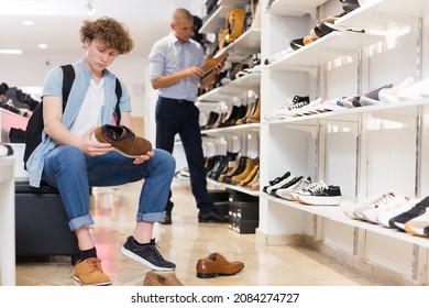 Teen Boy Trying On Classic Brown Shoes At Shoe Store