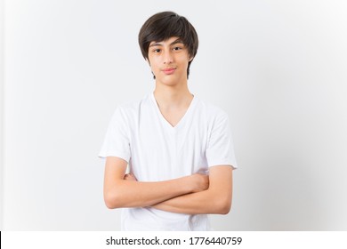 Teen Boy Wearing White T-shirt With Arms Folded Isolated On White Background. Handsome Child Looking At Camera.