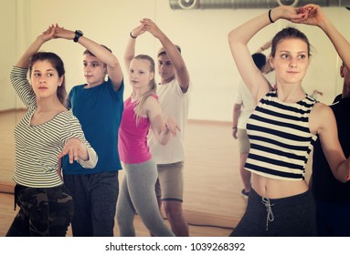 Teen boys and girls having dancing class in dance studio - Shutterstock ID 1039268392