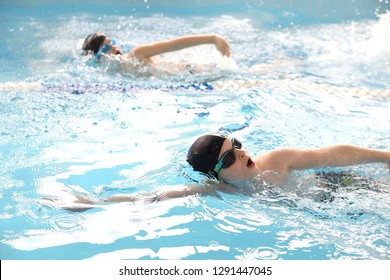 Teen Boys Swimming In The Pool At The Training In Swimming