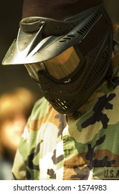 A Teen In Camouflage And Mask Ready For Paintball.