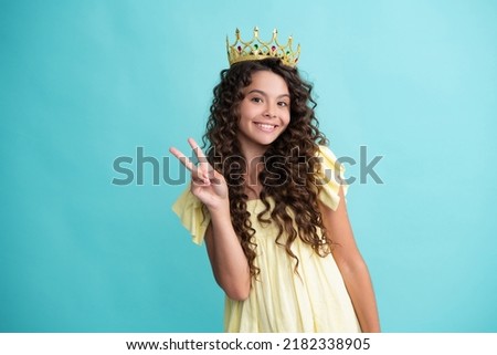 Teen child in queen crown isolated on blue background. Princess girl in tiara. Teenage girl wear diadem. Happy teenager, positive and smiling emotions of teen girl.