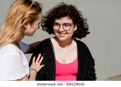 Teen comforting friend, sad girl talking about her problems