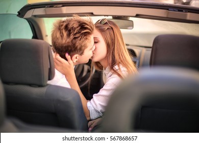 Teen couple kissing in the car 