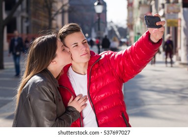 Teen Couple Taking A Selfie Photo In An Urban Street