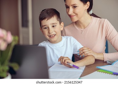 Teen Cute Boy With Braces Learning Homework At Laptop Computer And Mom Helping.