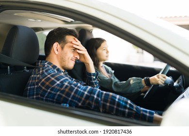 Teen Daughter Driving His Dad's Car Above The Speed Limit During Her Driving Lessons Next To Her Upset Looking Father