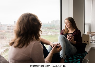 Teen Daughter With Mother Having Casual Talk In Home