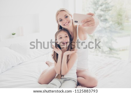 Teen different age older sister close relatives offspring mama mom mommy concept. Funny funky cute sweet lovely adorable carefree girls making taking self portrait picture on girlish pink smart phone