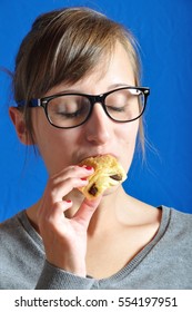 A  Teen Eating A Chocolat Bun