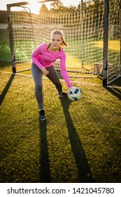 Teen Female Goalie Catching A Shot During A Soccer Game