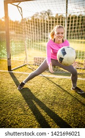 Teen Female Goalie Catching A Shot During A Soccer Game