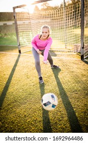 Teen Female Goalie Catching A Shot During A Soccer Game