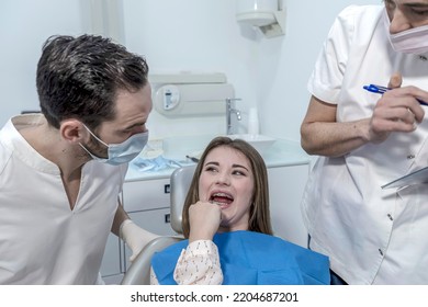 Teen Female With Toothache Pain Sitting To Dental Chair During Teeth Examination