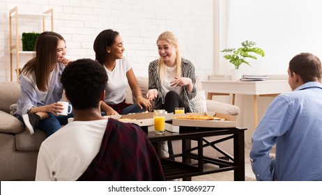 Teen friends chatting at home and eating pizza, having small party on weekend, panorama - Shutterstock ID 1570869277