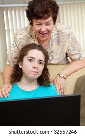 Teen Girl Annoyed By Her Aunt Watching Her Work On The Computer.