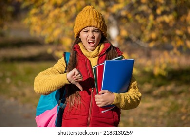 Teen Girl Back To School In Autumn. Thumb Down