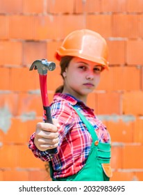 Teen Girl Builder In Protective Helmet Use Hammer, Building Tool