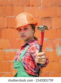 Teen Girl Builder In Protective Helmet Use Hammer, Building Tool