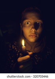 Teen Girl With A Candle, Fear On Her Face