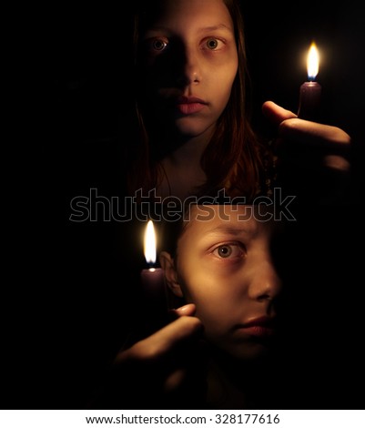 Teen girl with a candle, fear on her face