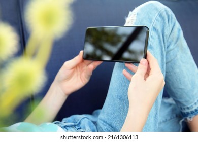 Teen Girl  Is Checking Social Media Holding Smartphone Outside.