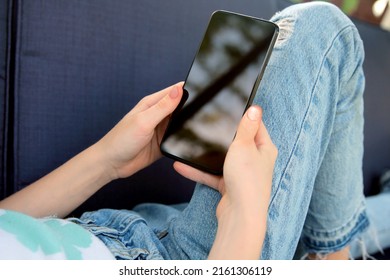 Teen Girl  Is Checking Social Media Holding Smartphone Outside.