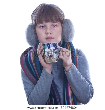 Teen girl with Christmas decorated cup in hands drinks tea isolated white