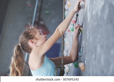 Teen Girl Climbing A Rock Wall Indoor