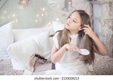 Teen Girl Combing Hair In Her Bedroom. Hair Care.