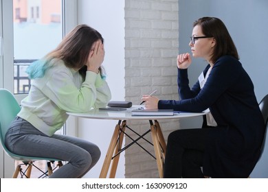 Teen Girl Covered Face With Hands At Meeting With Psychologist. Problems Of Adolescent Children, Help Of Therapist, Mental Health Of Young People