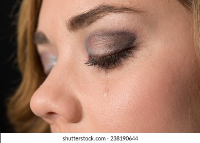 Teen Girl Crying, With A Tear Drop Running Down Her Cheek.  