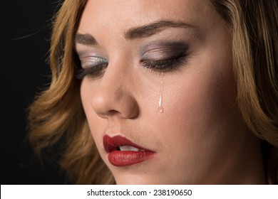 Teen Girl Crying, With A Tear Drop Running Down Her Cheek.  