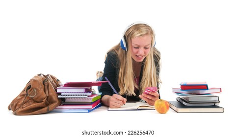 Teen girl with distraction bij the cell phone while making homework for school