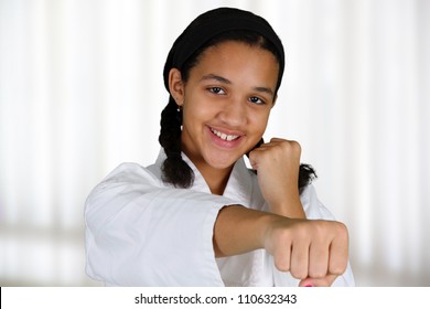 Teen girl doing karate at a studio