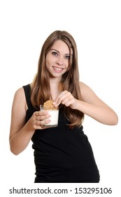 Teen Girl Dunking Oatmeal Cookie In Milk