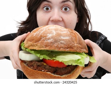 Teen Girl Eating Huge Giant Hamburger With Funny Expression.