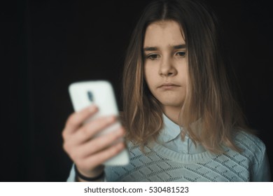 Teen Girl Excessively Sitting At The Phone At Home. He Is A Victim Of Online Bullying Stalker Social Networks