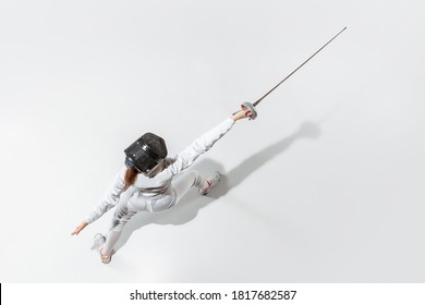 Teen girl fencing with sword on white background, top view. Sport, action