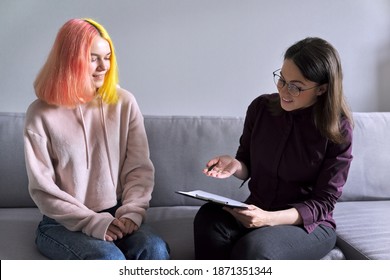 Teen girl giving interview to social worker. School psychologist talking with student, counseling, therapy, help and support for adolescents