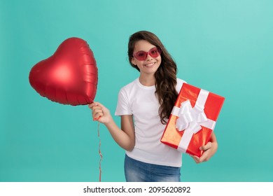 teen girl has birthday gift. child in sunglasses sharing box with ribbon. love heart.