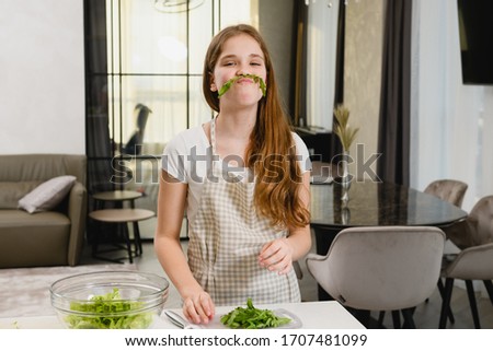 Teen girl have fun with green salad