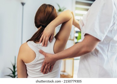 Teen Girl having chiropractic back adjustment. Osteopathy, Physiotherapy, Kinesiology. Bad posture correction