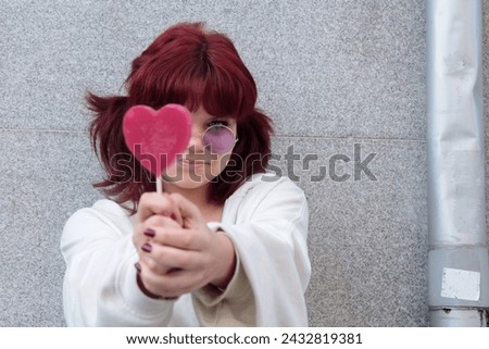 teen girl with heart lollipop