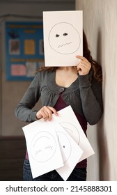 Teen Girl Hides Her Face Painted On A Piece Of The Mask Of Discontent