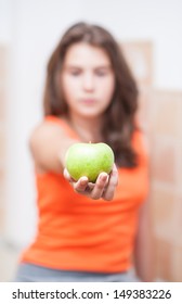 Teen Girl Holding A Beautiful, Fresh Green Apple Indoor, Selective